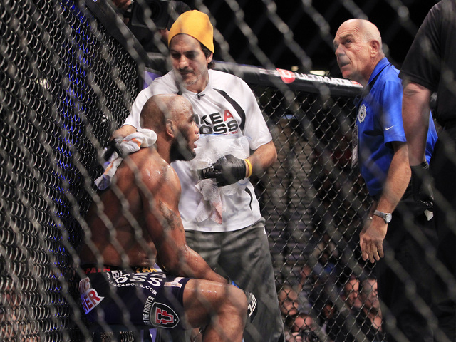 An official from the Nevada Athletic Commission stands by as Yoel Romero gets wiped down between rounds of his fight with Tim Kennedy during their fight at UFC 178 Saturday, Sept. 27, 2014 at the  ...