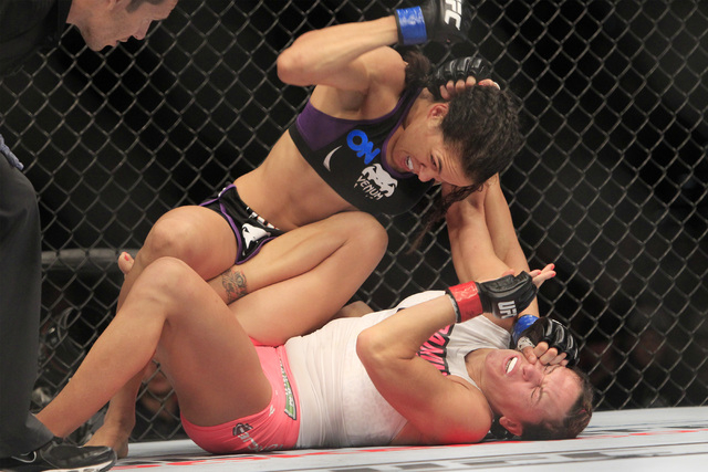 Cat Zingano is hit by Amanda Nunes during their fight at UFC 178 Saturday, Sept. 27, 2014 at the MGM Grand Garden Arena in Las Vegas. (Sam Morris/Las Vegas Review-Journal)