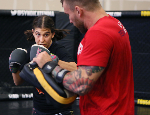 Mixed martial arts fighter Roxanne Modafferi, left, spars with her coach John Wood at Syndicate MMA Gym Wednesday, Aug. 27, 2014, in Las Vegas. Modafferi prepares for her upcoming all-female Invic ...