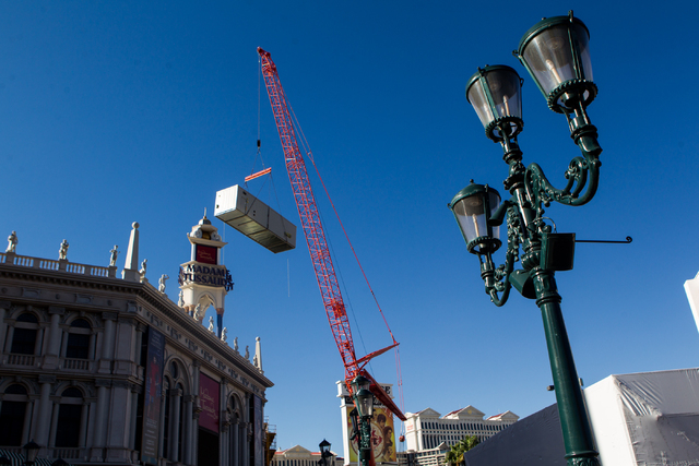 Part of a new central plant, upper left, is lifted by a crane as renovations go on at the Best Western Plus Casino Royale in Las Vegas on Wednesday, Sept. 17, 2014. Northbound lanes on Las Vegas B ...