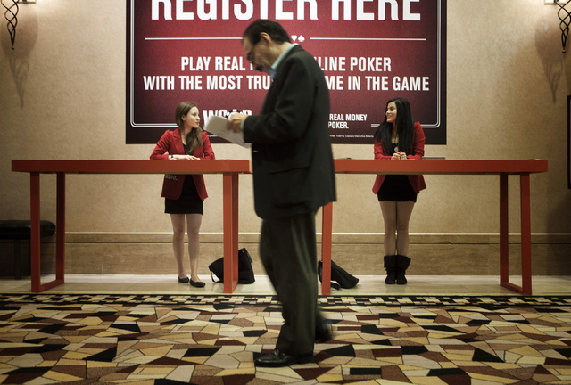 Estephania Solis, left, and Melina Gallego brand ambassadors for the World Series of Poker online, wait to sign up customers at the 2014 World Series of Poker at the Rio on Wednesday, July 9, 2014 ...