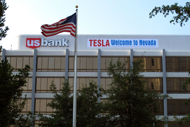 A banner welcoming Tesla to Nevada is hung on the US Bank building just south of the downtown Reno casino district on Tuesday, Sept. 9, 2014. State lawmakers are meeting in a special legislative s ...
