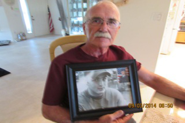 Walter Shersty poses with a photo of his son, Daniel, this week at his home in Port St. Lucie, Fla. (Photo courtesy Mary Ann Clate)