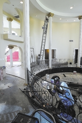A worker builds a safety rail in the living room of the mansion at the former estate of former Strip headliner Wayne Newton Tuesday, Aug. 27, 2013. The majority owners of the 38-acre site at the c ...