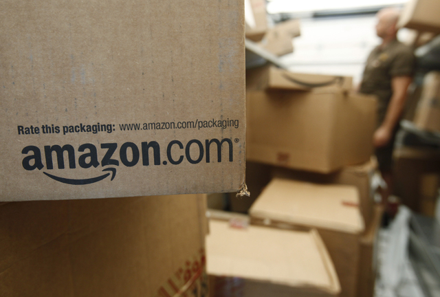 An Amazon.com package awaits delivery from UPS in Palo Alto, Calif. Amazon on Thursday, March 13, 2014 said it is raising the price of its popular Prime membership to $99 per year, an increase of ...