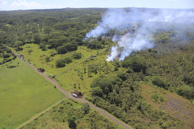 The lava flow from the Kalauea Volcano is seen split into two separate lobes in this aerial picture taken near the village of Pahoa, Hawaii, Friday, Oct. 24, 2014. (Reuters/U.S. Geological Survey ...