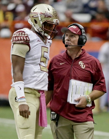 Florida State head coach Jimbo Fisher, right, talks to quarterback Jameis Winston (5) during the second half of an NCAA college football game against Syracuse, Saturday, Oct. 11, 2014, in Syracuse ...