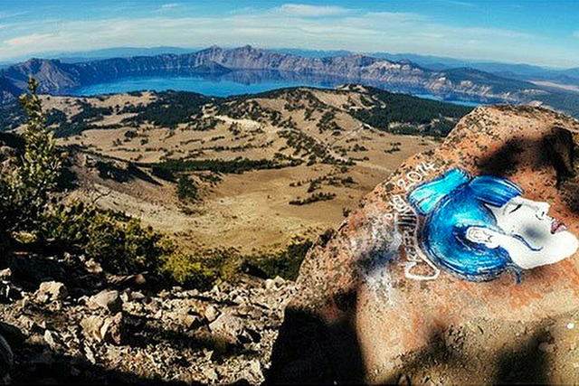 This undated photo taken from an Instagram posting shows an overlook of Crater Lake in Oregon with a rock painting. The National Park Service is investigating paintings and drawings of eerie faces ...