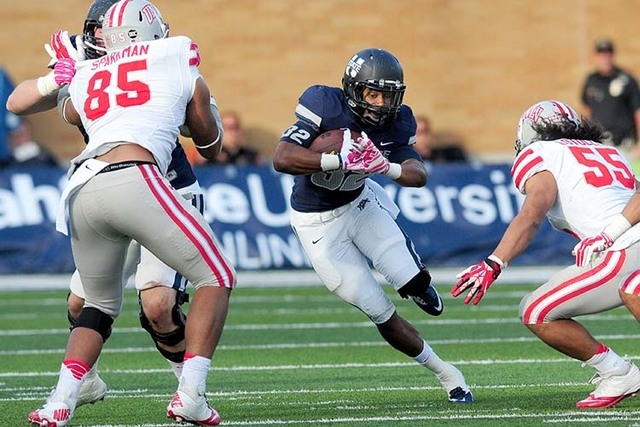 UNLV hasn't been able to stop the run this season. Utah State's Joe Hill, center, runs the ball gainst UNLV on Oct. 25, 2014, in Logan, Utah. (AP Photo/The Herald Journal, John Zsiray)