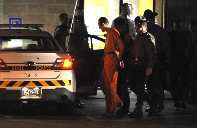 Erin Frein, suspected of shooting two Pennsylvania state troopers last month, is led from the state police barracks in Blooming Grove, Pa. on Friday, Oct. 31, 2014. Frein was arrested Thursday nig ...