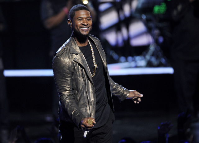 FILE - In this June 29, 2014 file photo, Usher performs at the BET Awards at the Nokia Theatre in Los Angeles. Usher launches his UR Experience World Tour in Montreal on Saturday, Nov. 1. (Photo b ...