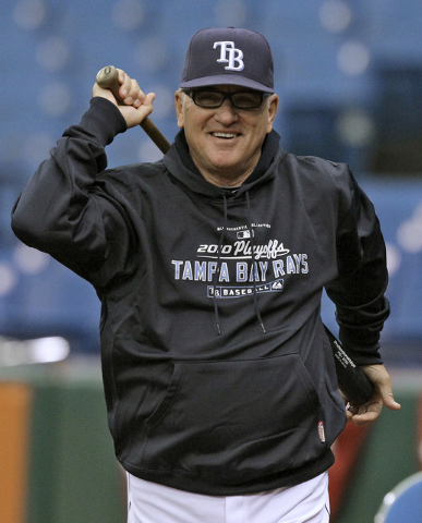 In this Oct. 5, 2010, file photo, Tampa Bay Rays manager Joe Maddon smiles as he looks on during baseball practice in St. Petersburg, Fla. The Cubs have fired manager Rick Renteria after one seaso ...