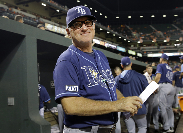 In this Aug. 27, 2014, file photo, Tampa Bay Rays manager Joe Maddon smiles at a fan in the stands in the fifth inning of a baseball game against the Baltimore Orioles in Baltimore. The Cubs have  ...