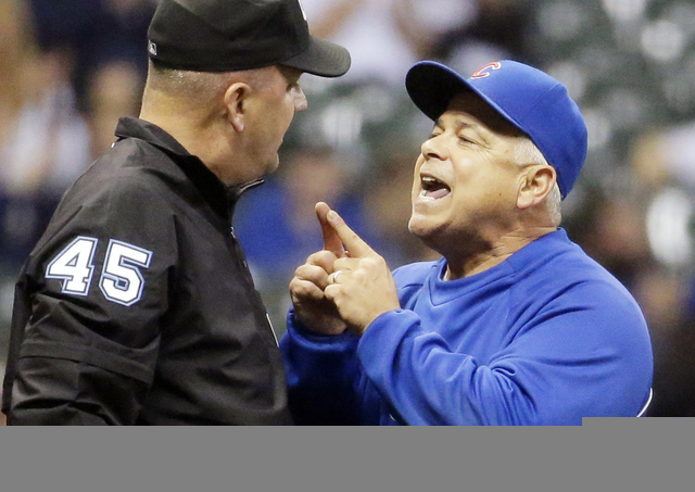 FILE - In this Sept. 26, 2014, file photo, Chicago Cubs manager Rick Renteria, right, argues with umpire Jeff Nelson during the eighth inning of a baseball game against the Milwaukee Brewers, in M ...