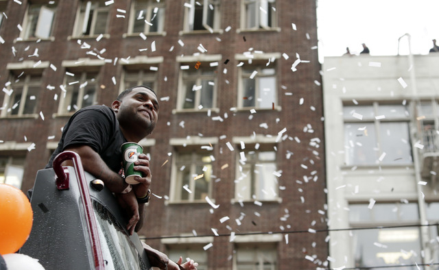 San Francisco Giants's Pablo Sandoval watches as confetti comes down during the victory parade for the 2014 baseball World Series champions, Friday, Oct. 31, 2014, in San Francisco. (AP Photo/Marc ...