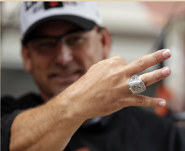 San Francisco Giants coach Mark Gardner flashes a World Series ring during the victory parade for the 2014 baseball World Series champions, Friday, Oct. 31, 2014, in San Francisco. (AP Photo/Marci ...