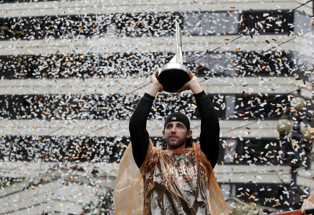 San Francisco Giants pitcher Madison Bumgarner holds the World Series MVP trophy during the victory parade for the 2014 baseball World Series champions, Friday, Oct. 31, 2014, in San Francisco. (A ...