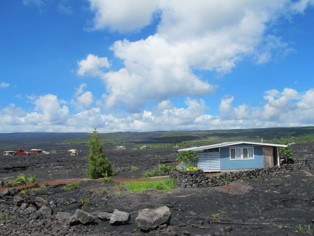 A house sits among recent lava flow in Kalapana, Hawaii on Thursday, Oct. 30, 2014. Ten miles from Pahoa, the small Hawaii town held hostage by a slowly oozing stream of lava from Kilauea volcano, ...