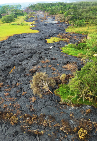 This Oct. 28, 2014 photo provided by Pete Stachowicz of Paradise Helicopters shows a lava flow near the town of Pahoa on the Big Island of Hawaii. The National Guard is deploying troops to the rur ...