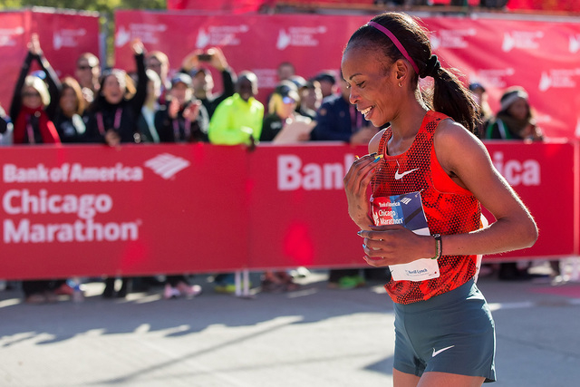 In this Sunday, Oct. 12, 2014 file photo, Rita Jeptoo of Kenya reacts after crossing the finish line to win the women's race during the Chicago Marathon, in Chicago, Illinois. The agent for Chicag ...