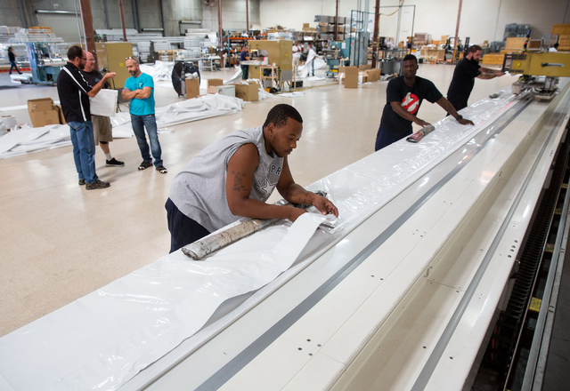 Devon Bryant cuts a beam cover at Creative Tent International, located at 451 Mirror Court suite 101 in Henderson on Monday, Oct. 6, 2014. The 10-year-old business manufactures and installs perman ...