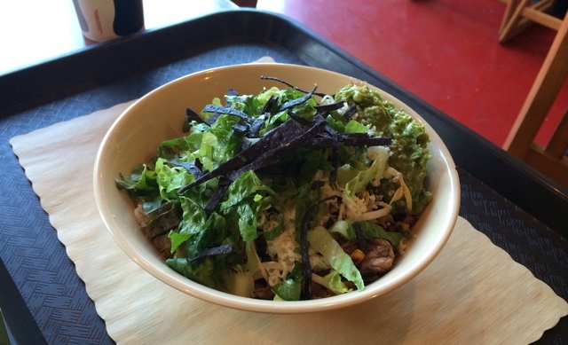 The Huli Huli chicken bowl with brown rice, black beans, guacamole and lettuce is shown at Braddah's Island Style, 6410 N. Durango Drive. (View file photo)