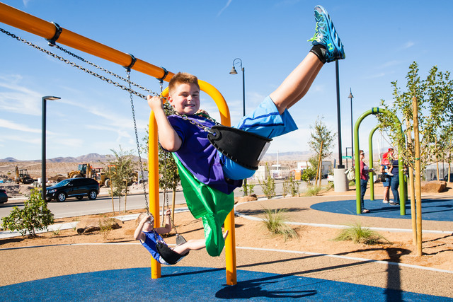 Owen McGibney, 10, enjoys the new swings at Capriola Park in Inspirada during its grand opening on Oct. 4. The $7 million park, 2155 Via Firenze, was funded by Inspirada Builders and is set to be  ...