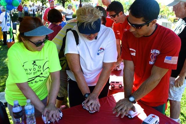 Las Vegas Firefighters teaching residents hands-only CPR at the Summerlin 5K Run and Fun Walk on Saturday, October 11, 2014. (Special to View)