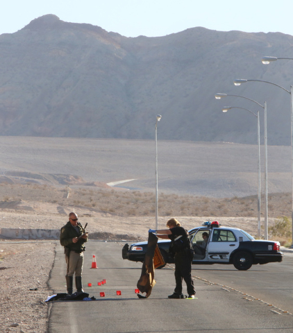 Las Vegas police investigate an accident scene Friday, Oct. 31, 2014, near Sahara Avenue and Hollywood Boulevard. Two men sitting on the trunk of a car driven by a 19-year-old female were seriousl ...