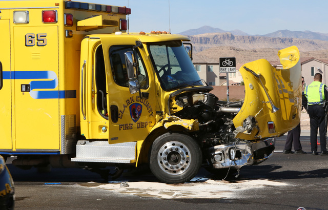 The intersection of Blue Diamond Road and Durango Drive is partially blocked after a Clark County fire truck and an SUV collided on Friday, Oct. 31, 2014. Four people were transported to a Las Veg ...