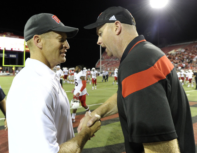 UNLV Rebels head coach Bobby Hauck, left, shakes hands with Northern Illinois Huskies head coach Rod Carey at the conclusion of their NCAA Football game at Sam Boyd Stadium in Las Vegas Saturday, ...
