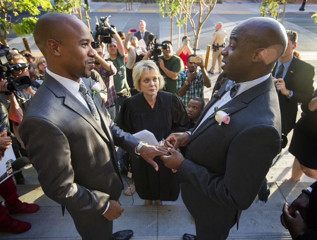 Sherwood Howard, left, and his husband Nevada Sen. Kelvin Atkinson, get married by District Court Judge Nancy Alf on the steps of the Regional Justice Center on Thursday, Oct. 9, 2014.  They were  ...