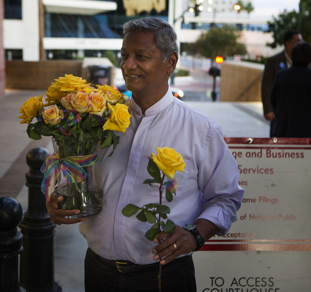 Reverend Ernie Martin  hands out flowers in front of the  County License Bureau on Thursday, Oct. 9, 2014.  Today is the first for  same-sex couples to get married in Clark County. (Jeff Scheid/La ...
