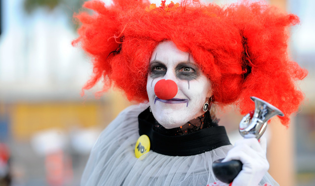 Hilarity Jane blows her horn before the start of the 5th annual Halloween parade along East Fremont Street in Las Vegas on Friday, Oct. 31, 2014. (David Becker/Las Vegas Review-Journal)