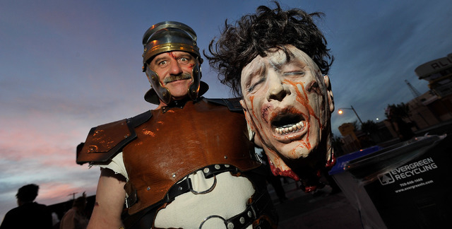 Dennis Laidlaw, as a gladiator, poses with his winning head, during the 5th annual Halloween parade along East Fremont Street in Las Vegas on Friday, Oct. 31, 2014. (David Becker/Las Vegas Review- ...