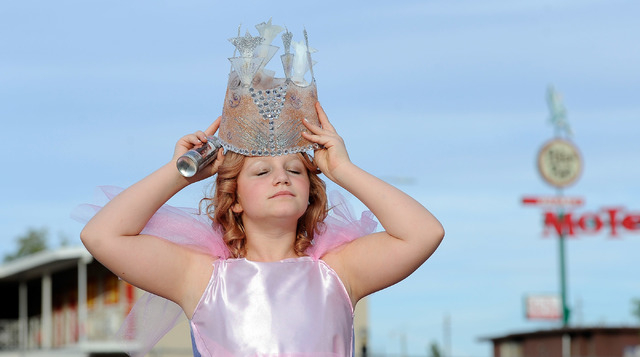 Morgane Rexroad, 10, dons her crown as she dresses like 'The Wizard of Oz's" good witch of the north before the start of the 5th annual Halloween parade along East Fremont Street in Las Vegas ...