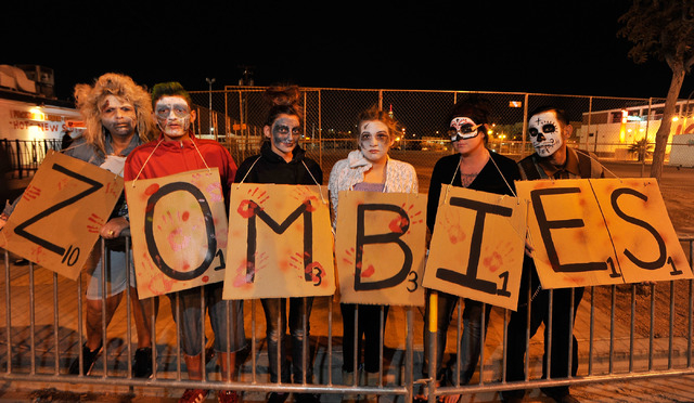 The Scrabble zombies from left, Wendy Mathre, Mikey Otto, Makaela Otto, Brianna Mathre, Wendy Otto and Carlos Lopez line up to watch the 5th annual Halloween parade along East Fremont Street in La ...