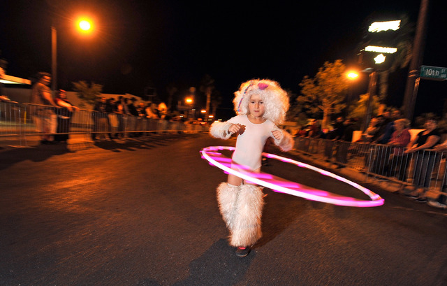Padi Anonima, 7, swings her Hula-Hoop as she walks during the 5th annual Halloween parade along East Fremont Street in Las Vegas on Friday, Oct. 31, 2014. (David Becker/Las Vegas Review-Journal)