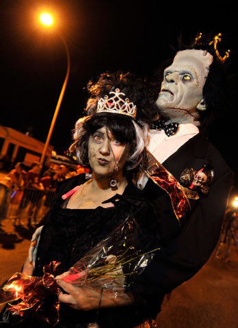 Jennifer Neri, with her prom date, Frankenstein, walk during the 5th annual Halloween parade along East Fremont Street in Las Vegas on Friday, Oct. 31, 2014. (David Becker/Las Vegas Review-Journal)