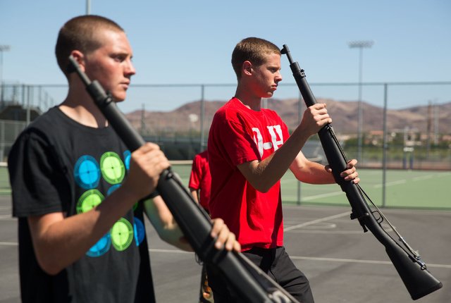 Basic High School Junior ROTC members James Werner, 16, left, and Colby Cazett, 17, right, practice their armed drill team program at the high school Friday, Sept. 19, 2014. (Samantha Clemens-Kerb ...