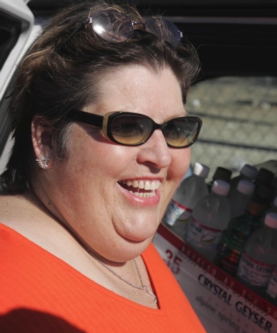 Homeless advocate Linda Lera-Randle El, founder and director of the Straight From the Streets charity, laughs while handing out water to homeless men in Las Vegas, Wednesday morning, Aug. 25, 2004 ...