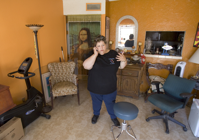 Homeless advocate Linda Lera-Randle El, founder and director of the Straight From the Streets charity, talks on the phone in her Las Vegas home, Feb. 10, 2006. Lera-Randle El was voted Favorite Fe ...