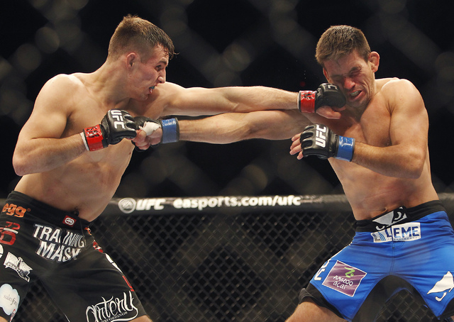 Rory MacDonald, left, hits Demian Maia during UFC 170 at the Mandalay Bay Events Center in Las Vegas on Saturday night, Feb. 22, 2014.  (Jason Bean/Las Vegas Review-Journal)
