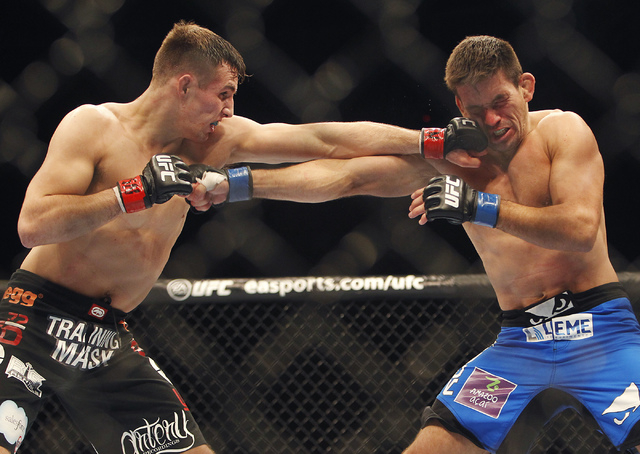 Rory MacDonald, left, hits Demian Maia during UFC 170 at the Mandalay Bay Events Center in Las Vegas on Saturday night, Feb. 22, 2014. (Jason Bean/Las Vegas Review-Journal)