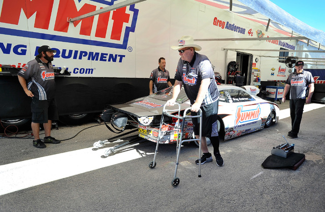 Team owner Ken Black, uses a walker to walk by his race cars before a pro stock qualifying session at the 14th annual NHRA Nationals at The Strip at the Las Vegas Motor Speedway on Friday, Oct. 31 ...