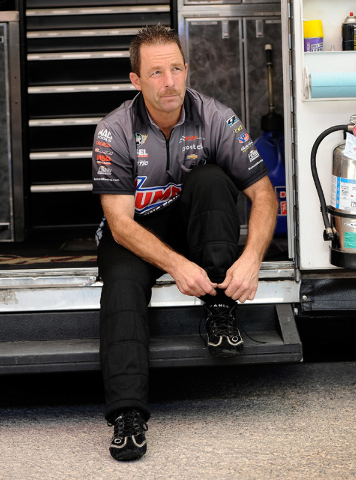 Driver Greg Anderson suits up  before a pro stock qualifying session at the 14th annual NHRA Nationals at The Strip at the Las Vegas Motor Speedway on Friday, Oct. 31, 2014. (David Becker/Las Vega ...