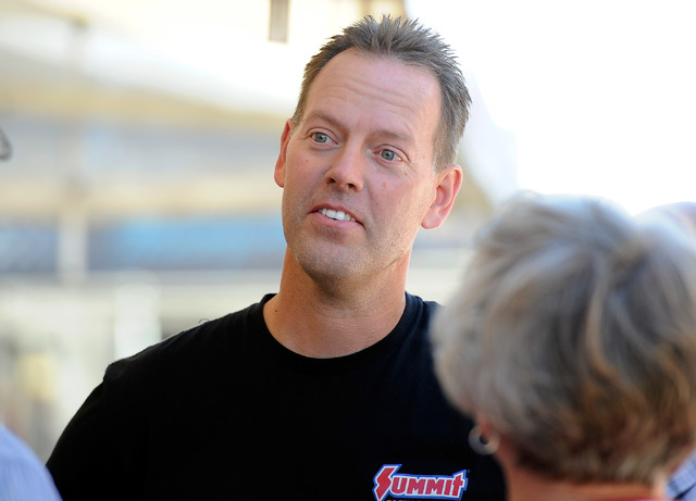 Driver Jason Line speaks with fans before a pro stock qualifying session at the 14th annual NHRA Nationals at The Strip at the Las Vegas Motor Speedway on Friday, Oct. 31, 2014. (David Becker/Las  ...