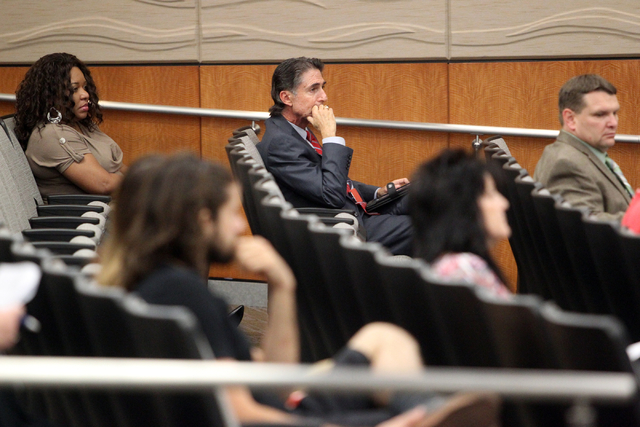 North Las Vegas spokesperson Mitch Fox, center, listens during a council meeting at City hall Wednesday, Oct. 1, 2014. Animal activists attended the meeting to demand explanations from Councilman ...