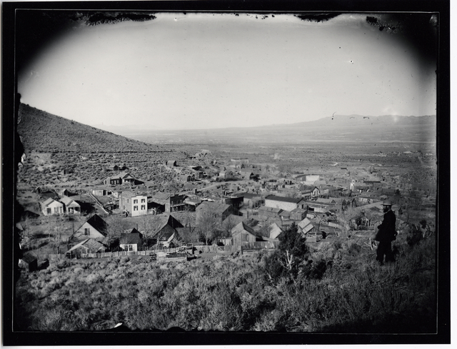 A man stands on a rise above the Lincoln County seat of Pioche in this undated photo. The rough and tumble mining town boomed in the late 1800s. (Courtesy of UNLV Special Collections)