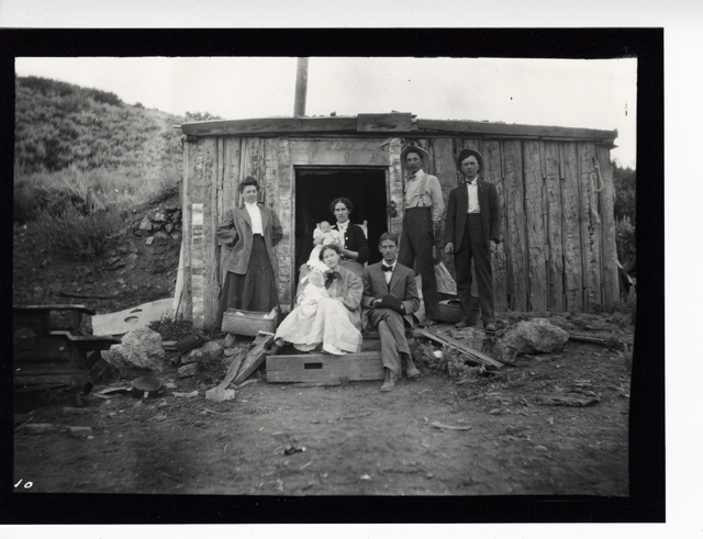 An undated photo shows people posed in front of a miner's cabin in Pioche. In an 1873 report, a state mining official described the town as the sort of place where you could "get shot very ea ...